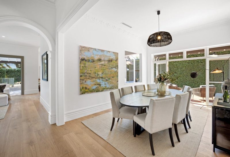 Formal dining with doors to the private side garden, and a servery from the working kitchen