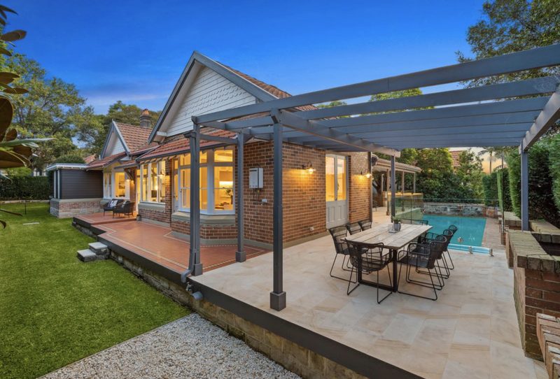 A pergola covers an entertaining area which connects the garden and existing pool