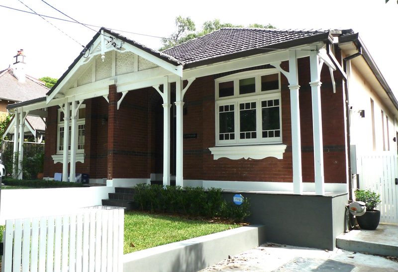 Restored Federation brick bungalow with original front verandah, seen from the street, Summer Hill