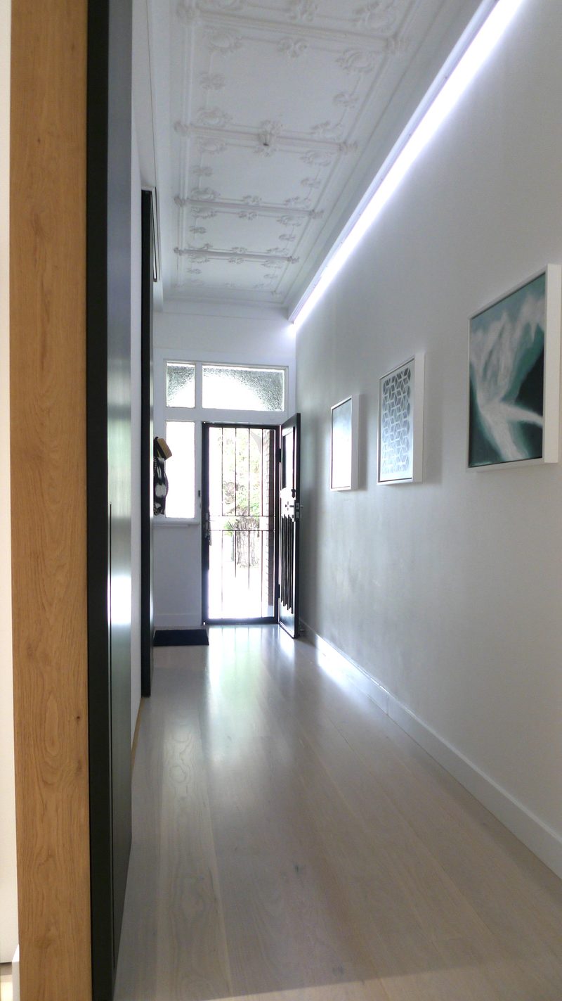 Few original details were able to be salvaged but the ceiling from the front door acts as an anchor to the building's roots. New flooring throughout was needed, and adds unity and flow through the house.