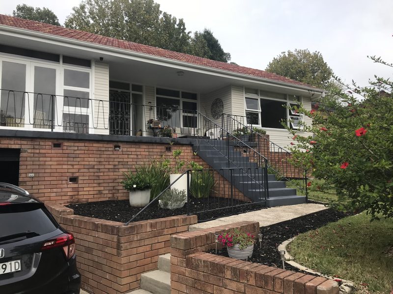 Before: the original house, with its brick base and steps up from the driveway