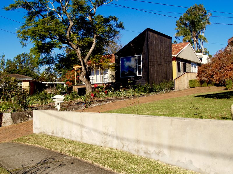 The house from the street, the dark timber addition standing beside the original