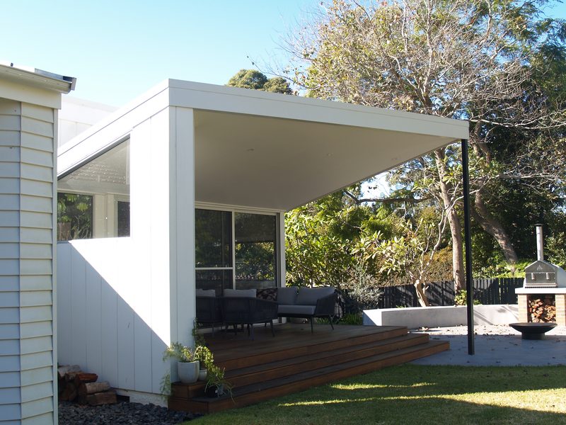 The covered outdoor room and its raking roof, from the garden