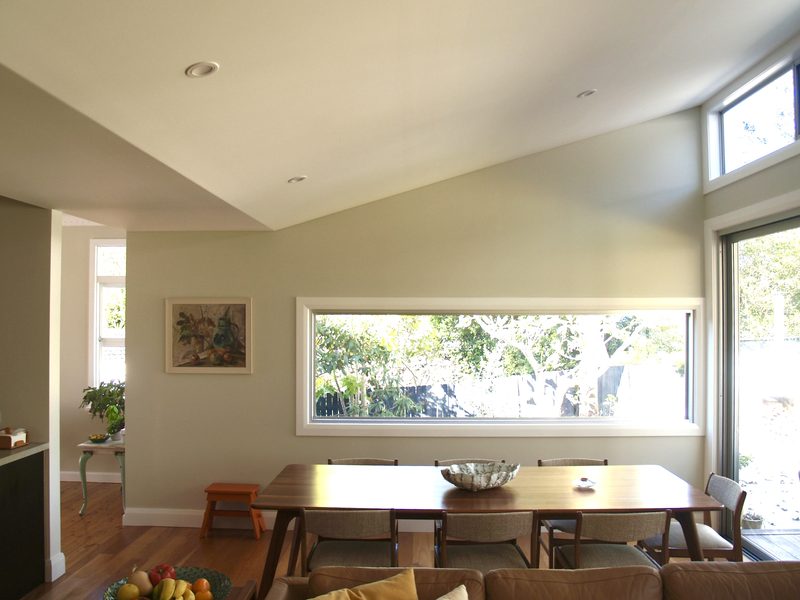 Dining room with a long picture window framing the garden